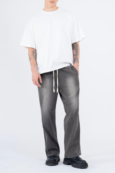 RELAXED DENIM FLARED PANTS IN PIGMENT WASHED